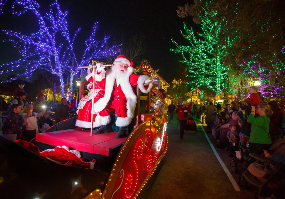 Santa Claus on sled during parade waving hello
